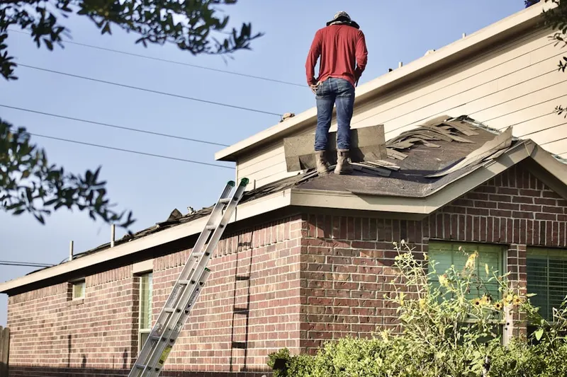 Professional roofer working on a residential roof in Elwood Park